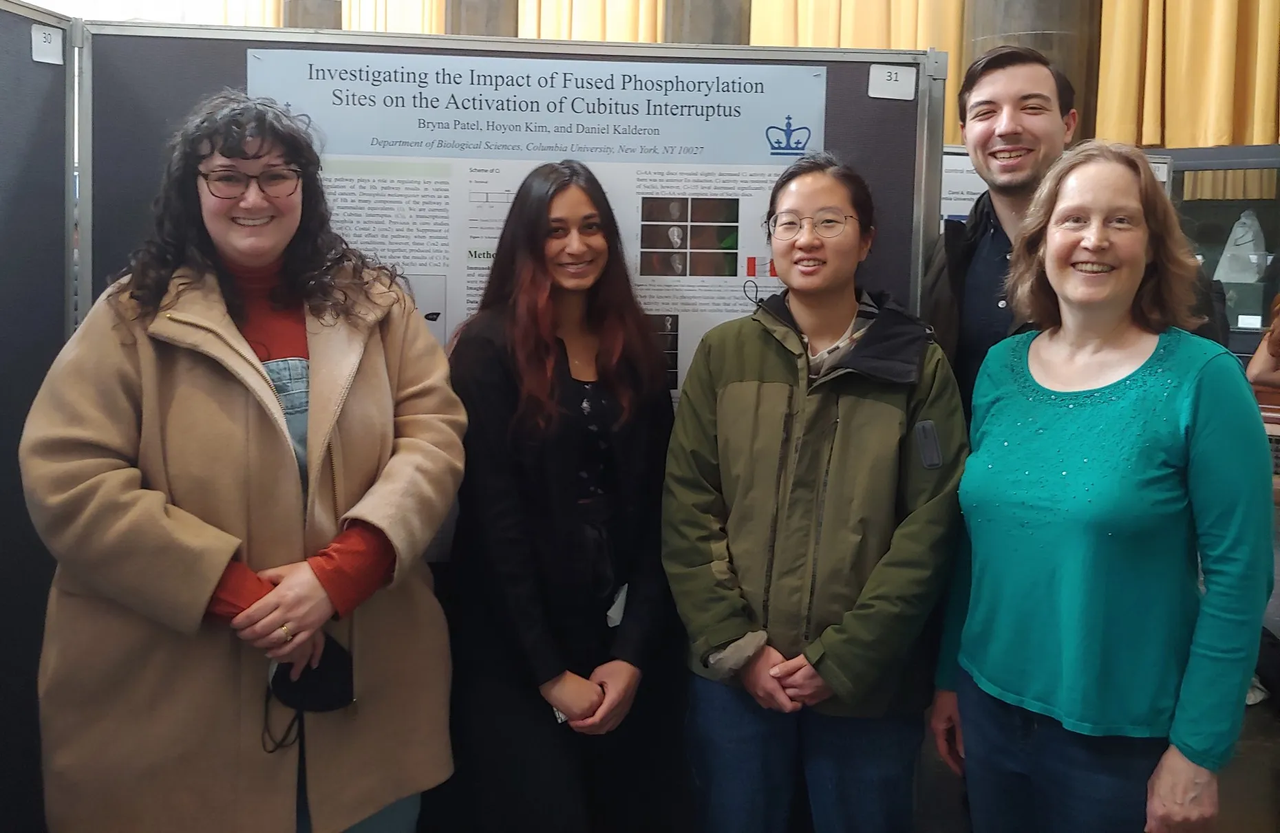 Lab members gathered in front of Bryna's research poster about Fused phosphorylation and Cubitus interruptus activation.